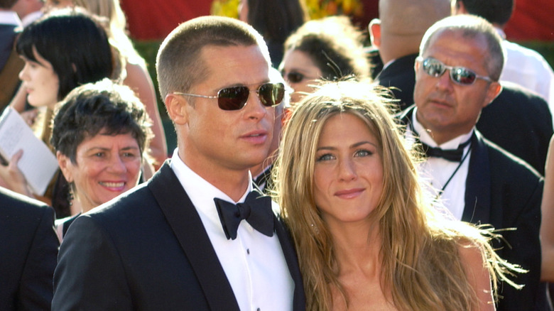 Brad Pitt and Jennifer Aniston posing on red carpet