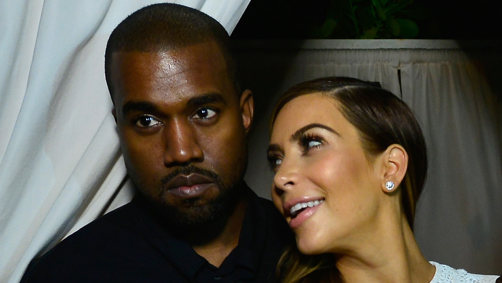 Kanye West and Kim Kardashian close up where she's smiling at him