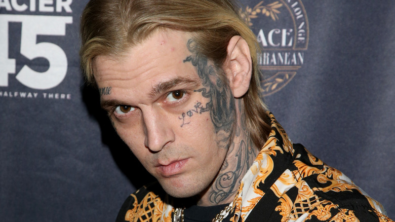 Aaron Carter posing face tattoos