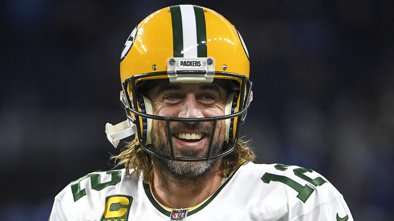 Aaron Rodgers smiles on the football field