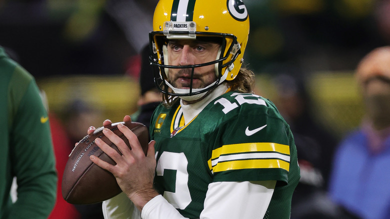 Aaron Rodgers throwing a football on the field