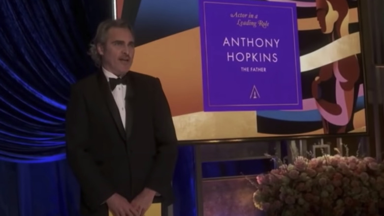 Joaquin Phoenix presents the Best Actor award to an absent Anthony Hopkins at the 2021 Oscars