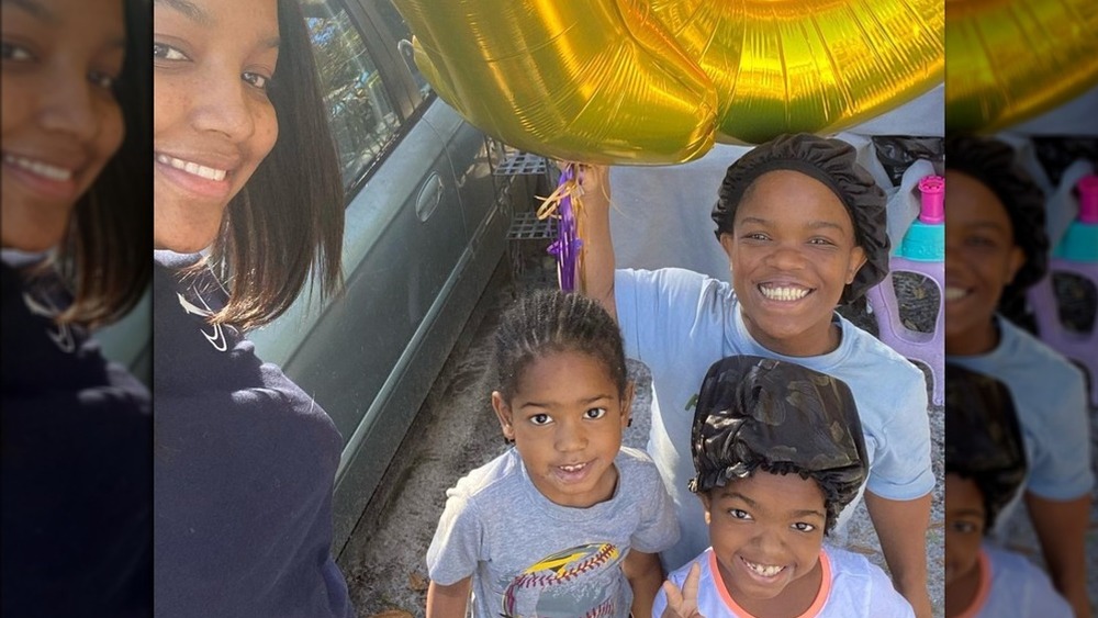 Abira Greene smiling with her children 