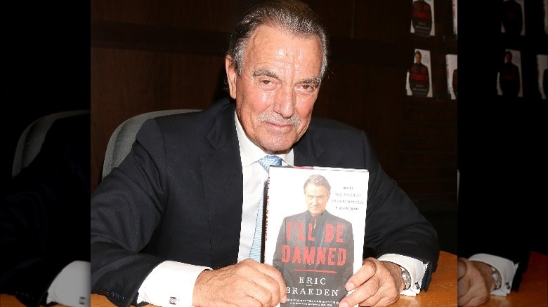 Eric Braeden holding a copy of his memoir
