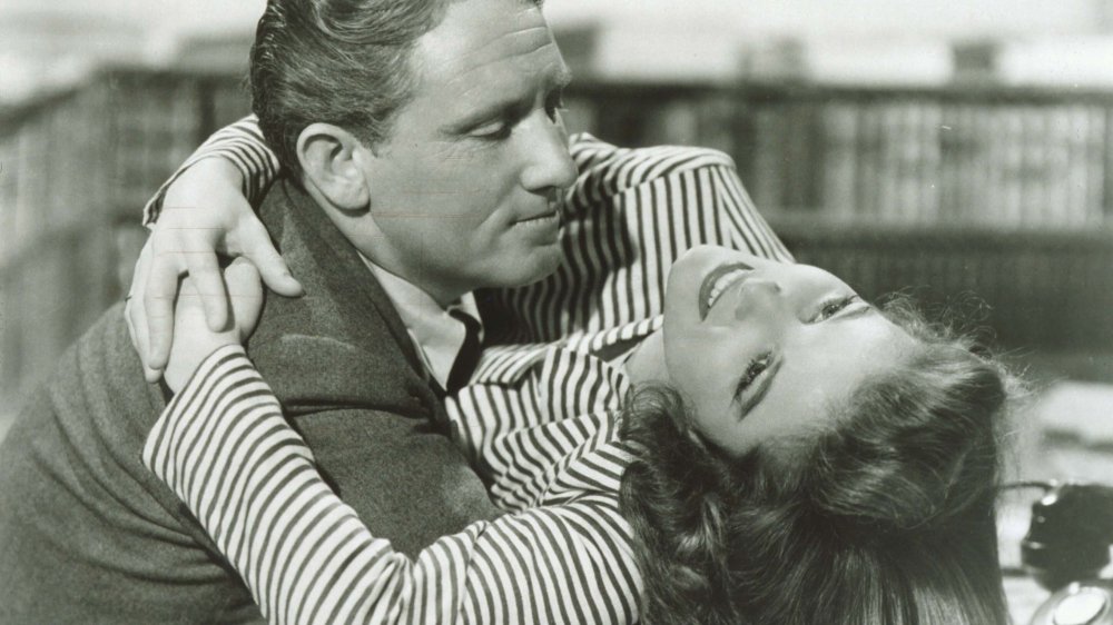 Black-and-white photo of Spencer Tracy holding a smiling Katherine Hepburn