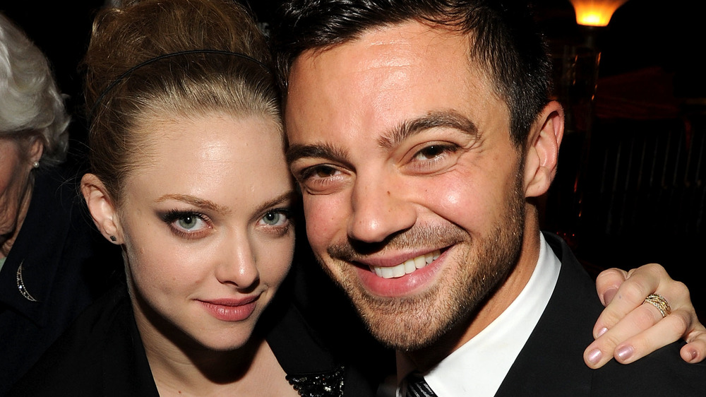 Amanda Seyfriend and Dominic Cooper smiling cheek-to-cheek