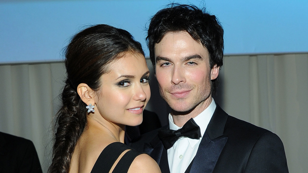 Nina Dobrev and Ian Somerhalder hugging and smirking 