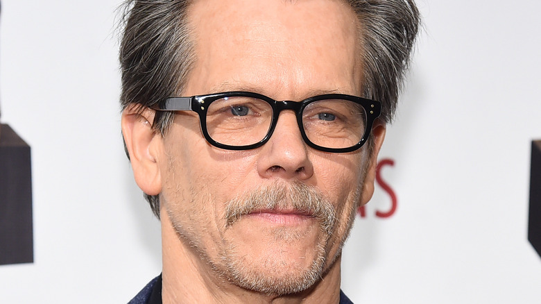 Kevin Bacon posing in glasses 