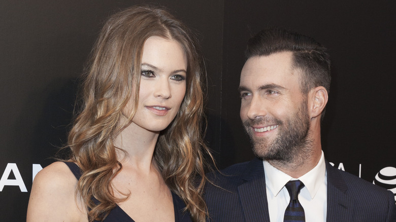 Adam Levine smiling at Behati Prinsloo