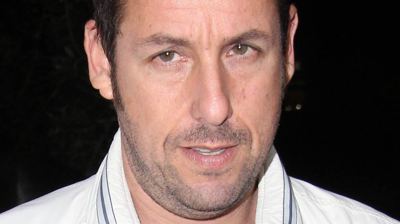 Adam Sandler in a white jacket