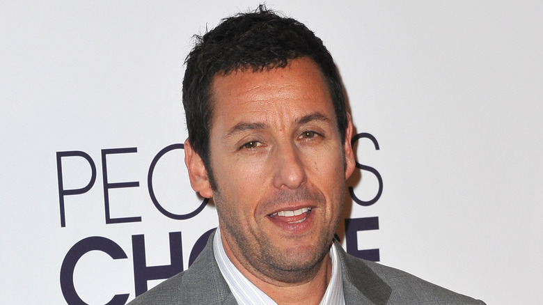 Adam Sandler in a gray suit