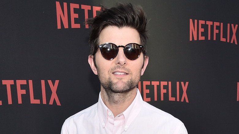 Adam Scott posing in sunglasses