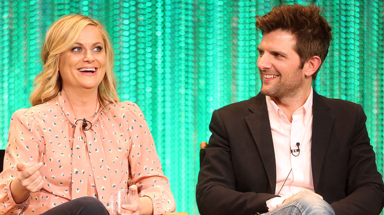 Adam Scott smiling at Amy Poehler 