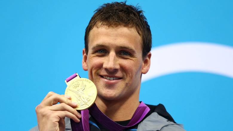 Ryan Lochte with gold medal in hand