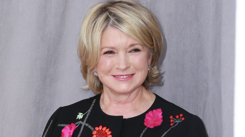 Martha Stewart in front of curtains 