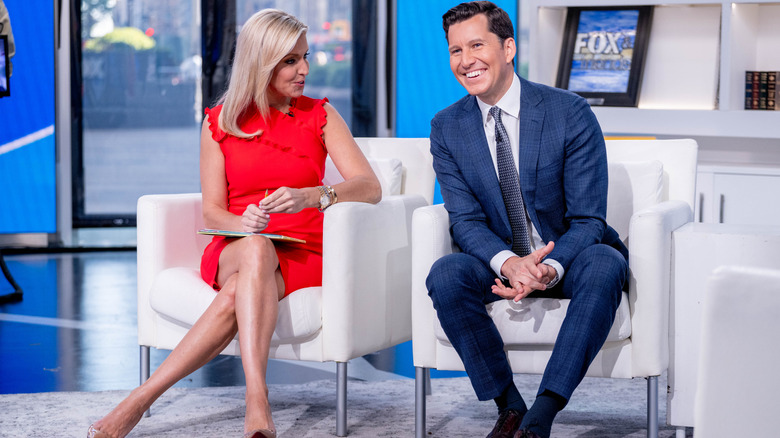 Ainsley Earhardt seated and wearing short red dress