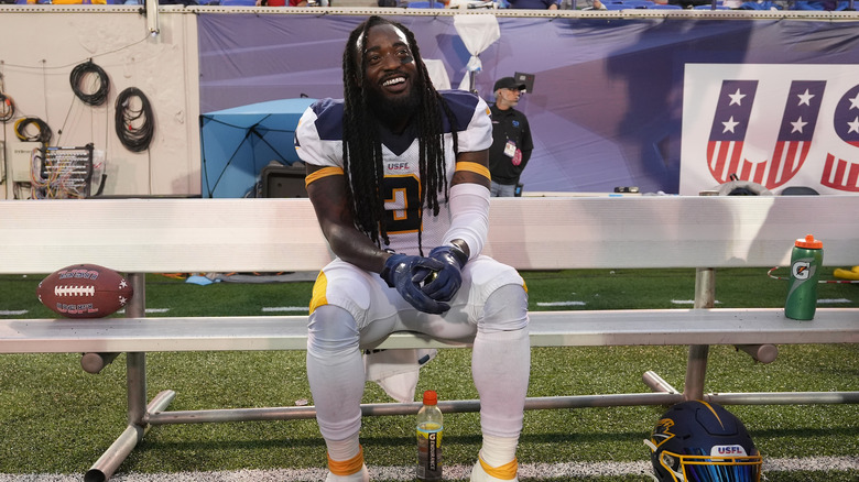 Alex Collins sitting on bench