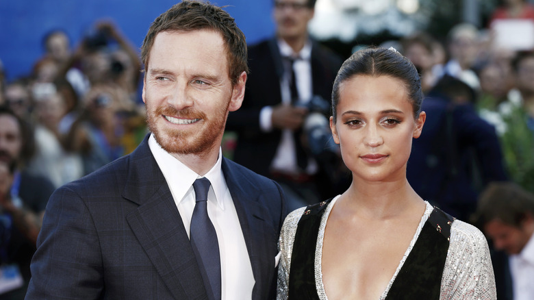 Michael Fassbender, Alicia Vikander posing