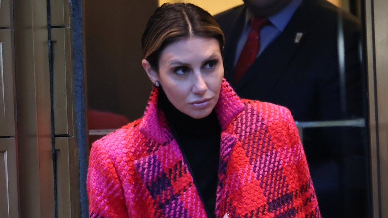 Alina Habba walking in a pink coat