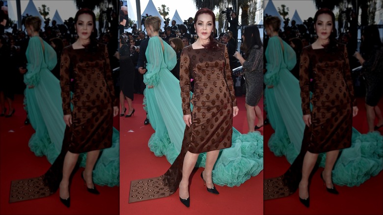 Priscilla Presley posing in brown dress at Cannes