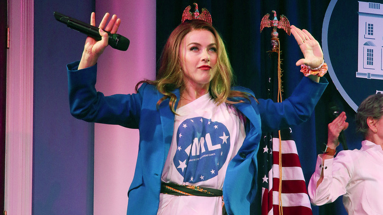 Julianne Hough poses with her hands up during a Broadway performance