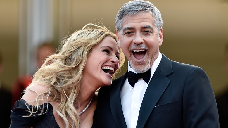 Julia Roberts and George Clooney laughing on red carpet