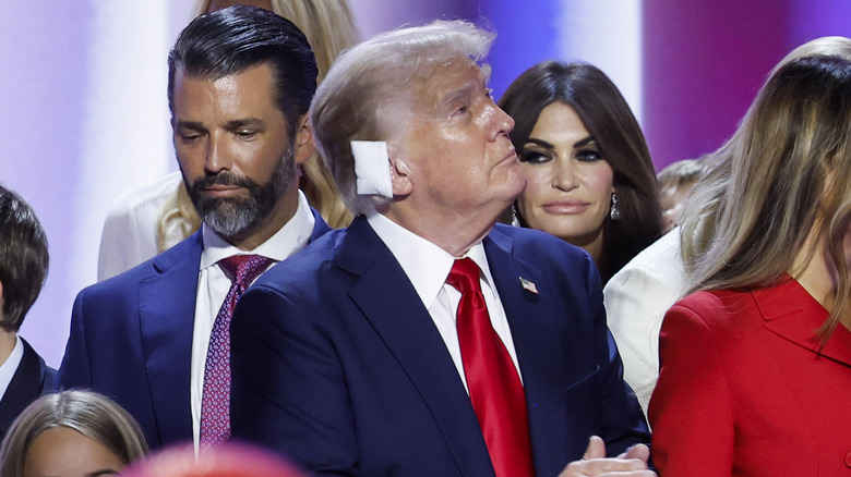 Donald Trump Jr., Donald Trump and Kimberly Guilfoyle on stage