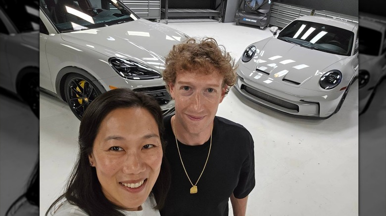 Priscilla Chan and Mark Zuckerbeg in front of Porsches