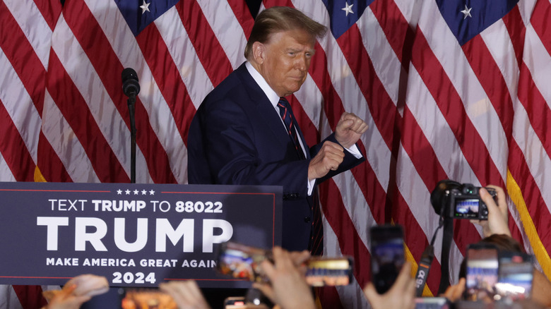 Donald Trump with closed fists onstage