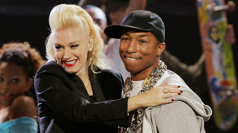 Gwen Stefani and Pharrell smiling on stage