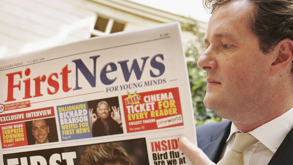 Piers Morgan reading a newspaper 