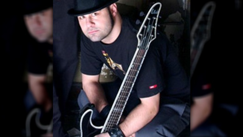 Bryan Ottoson posing with his guitar