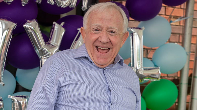 Leslie Jordan smiling in front of balloons