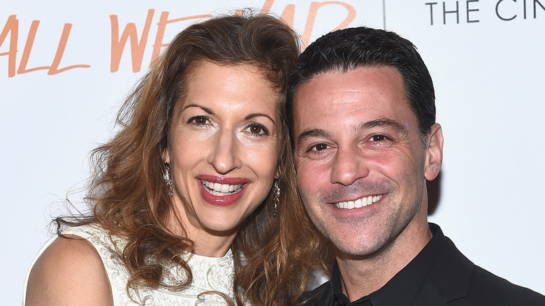 Alysia Reiner and husband David Basche posing on the red carpet