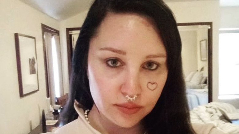 Amanda Bynes sad with heart tattoo on face