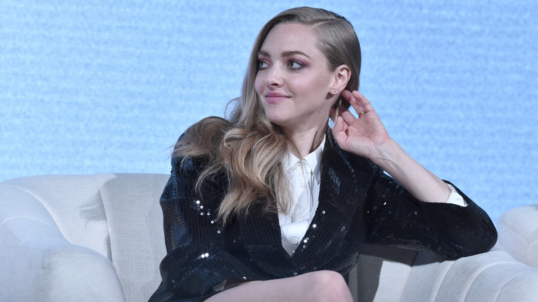 Amanda Seyfried sitting on a couch