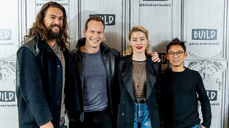 Amber Heard and the cast of Aquaman posing for a picture