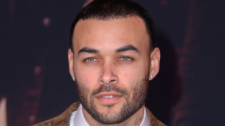 Don Benjamin wearing stud earrings