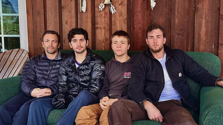 Andrew Shue seated with his three sons