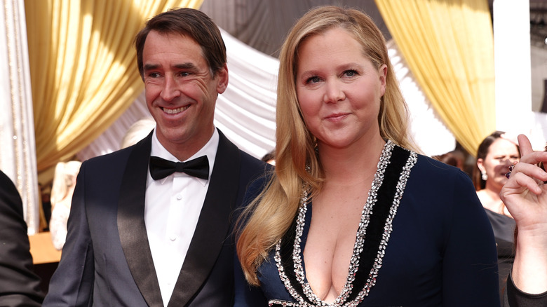 Amy Schumer and Chris Fischer pose at the Oscars