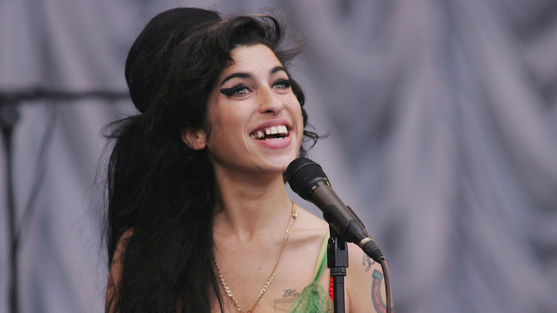 Amy Winehouse smiling tooth missing