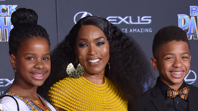 Angela Bassett posing with her two children