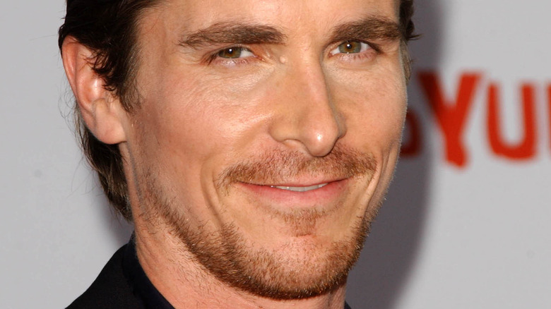 Christian Bale with a sly smile