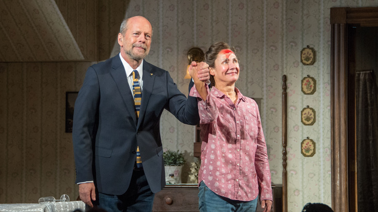 Bruce Willis and Laurie Metcalf holding hands