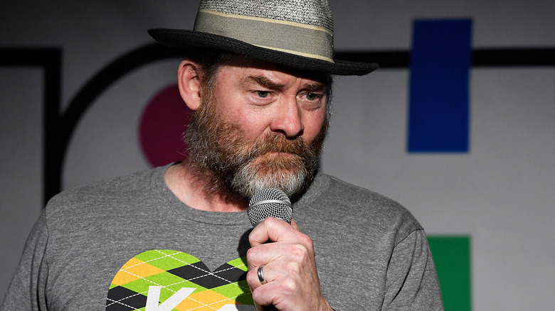 David Koechner on stage with a microphone