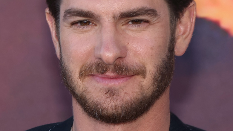 Andrew Garfield with beard slight smiling