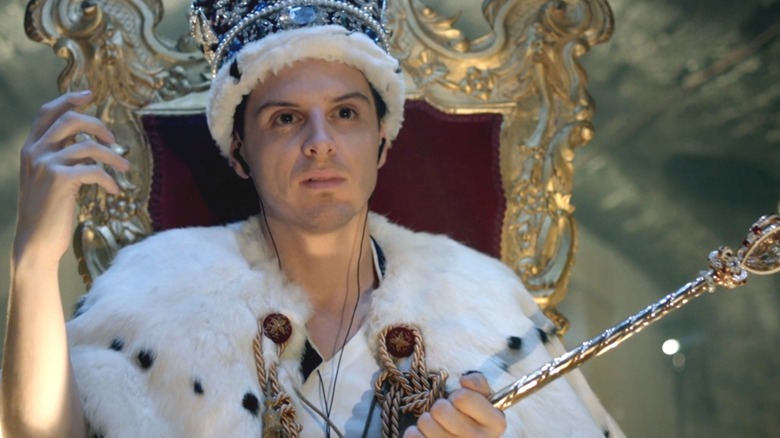 Andrew Scott as Moriarty sitting on a throne