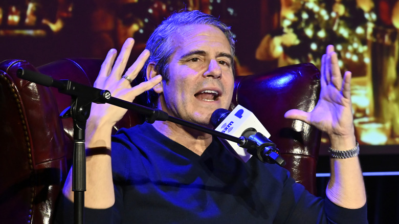 Andy Cohen speaking into microphone