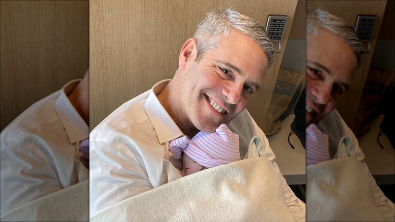 Andy Cohen swaddling baby Lucy