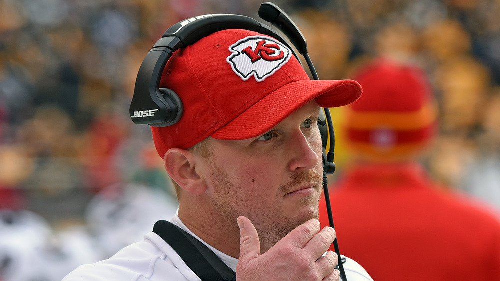 Britt Reid standing on the field wearing a cap and headset